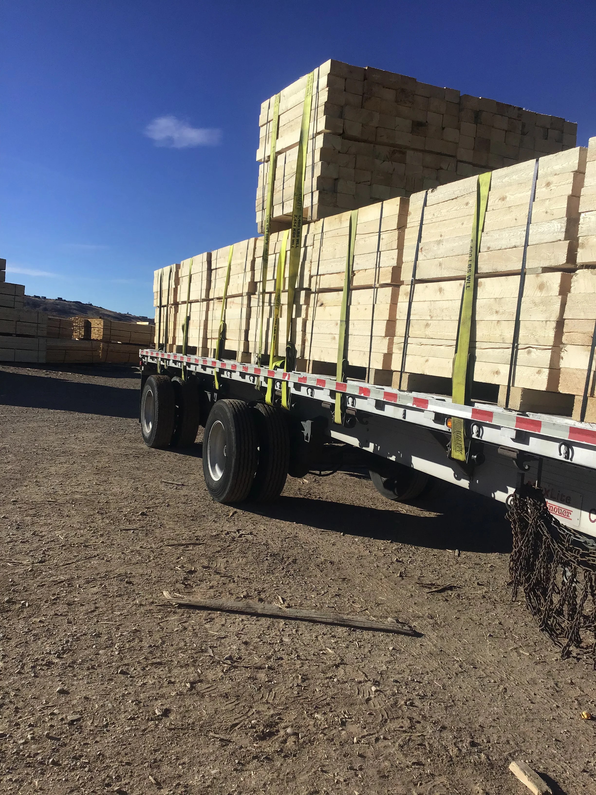 Flatbed trailer loaded with bundled lumber